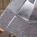 Hard faced reclaimer bucket